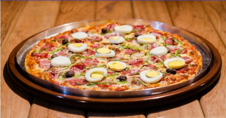 Which three pizza places in Abuja are a must-try